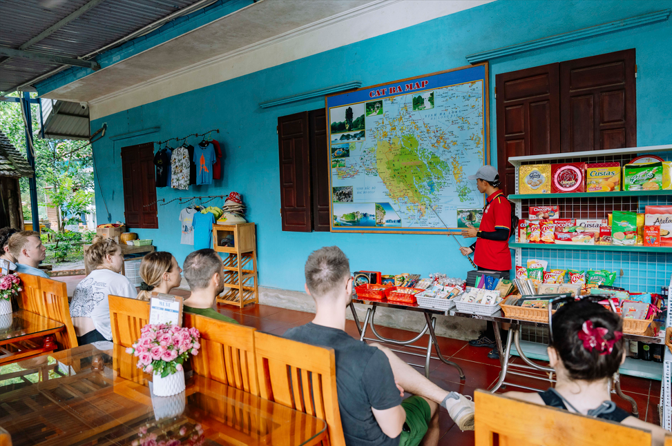 Our guide is providing an overview of Viet Hai Village to the visitors